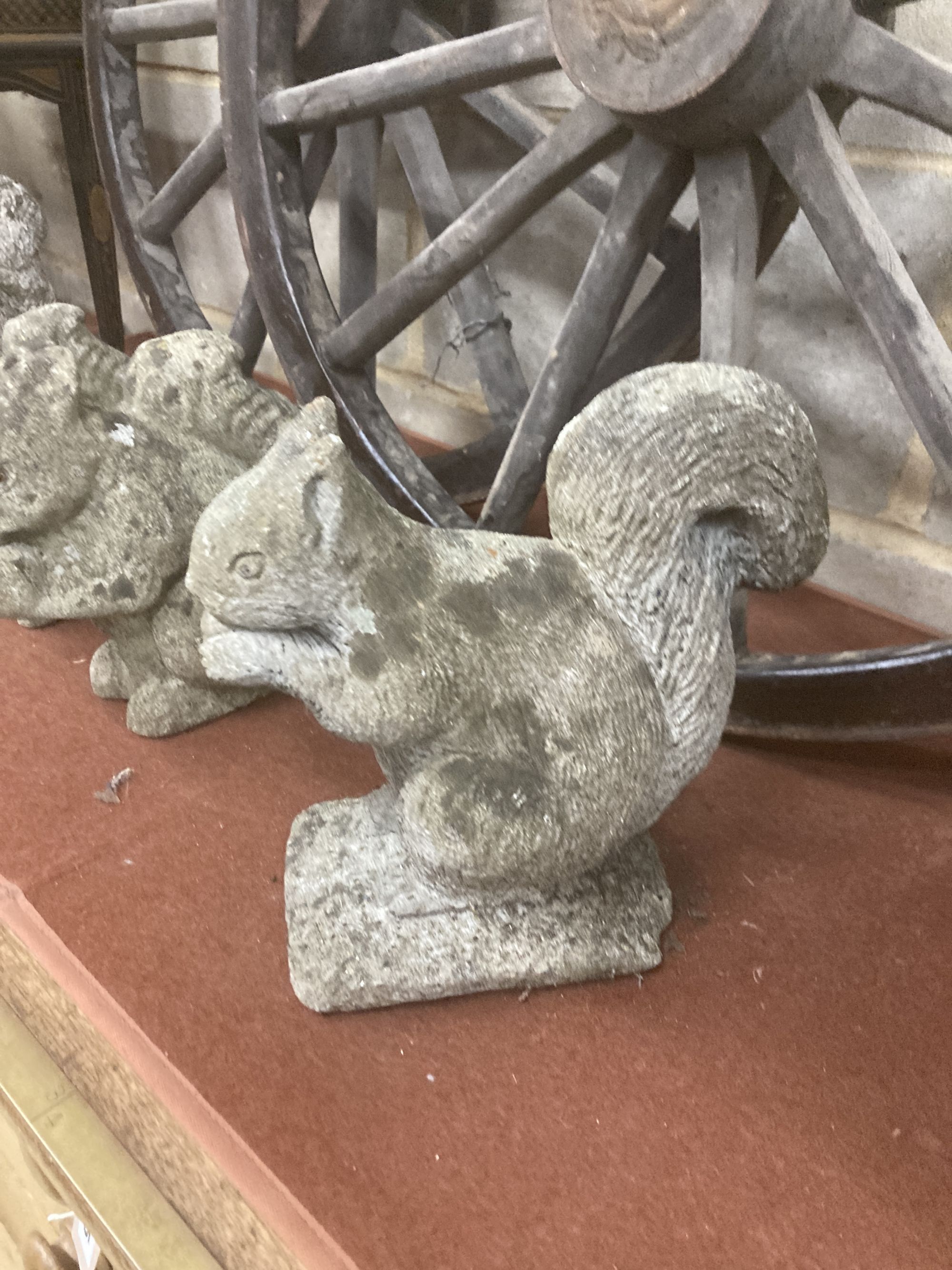Four reconstituted stone squirrel garden ornaments, largest 26cm high